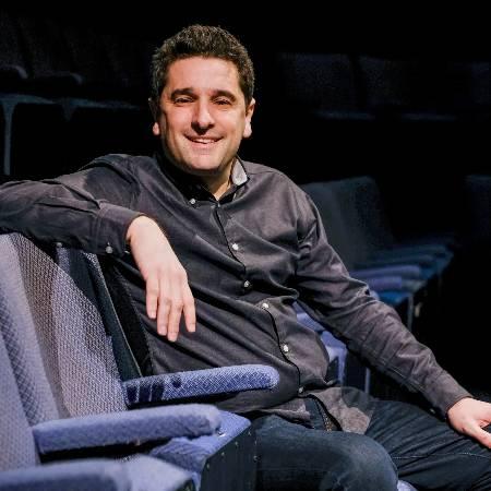 Paul Robinson, seated in the theatre auditorium