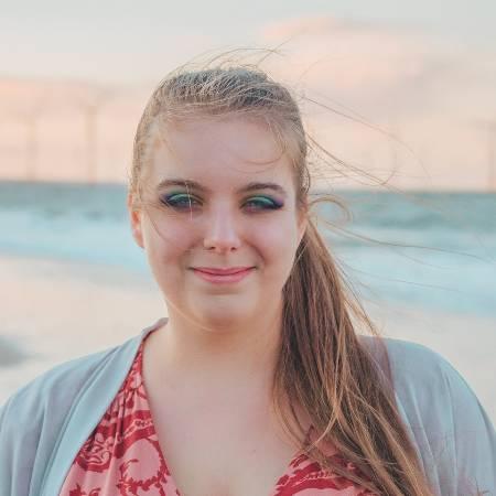 Photograph of Lizzie Lovejoy standing on a beach