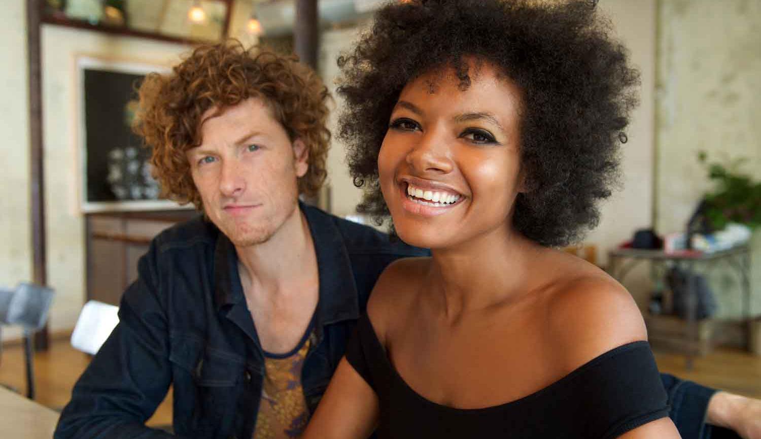 Photo of man and woman sitting at a bar