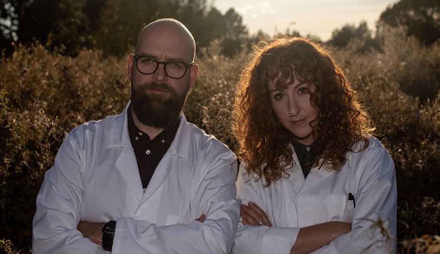 Findlay Napier and Megan Henwood standing side by side wearing white lab coats