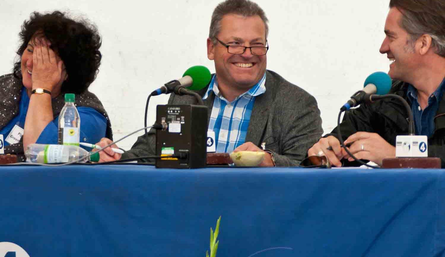 Panel of three people sat behind table covered in blue cloth