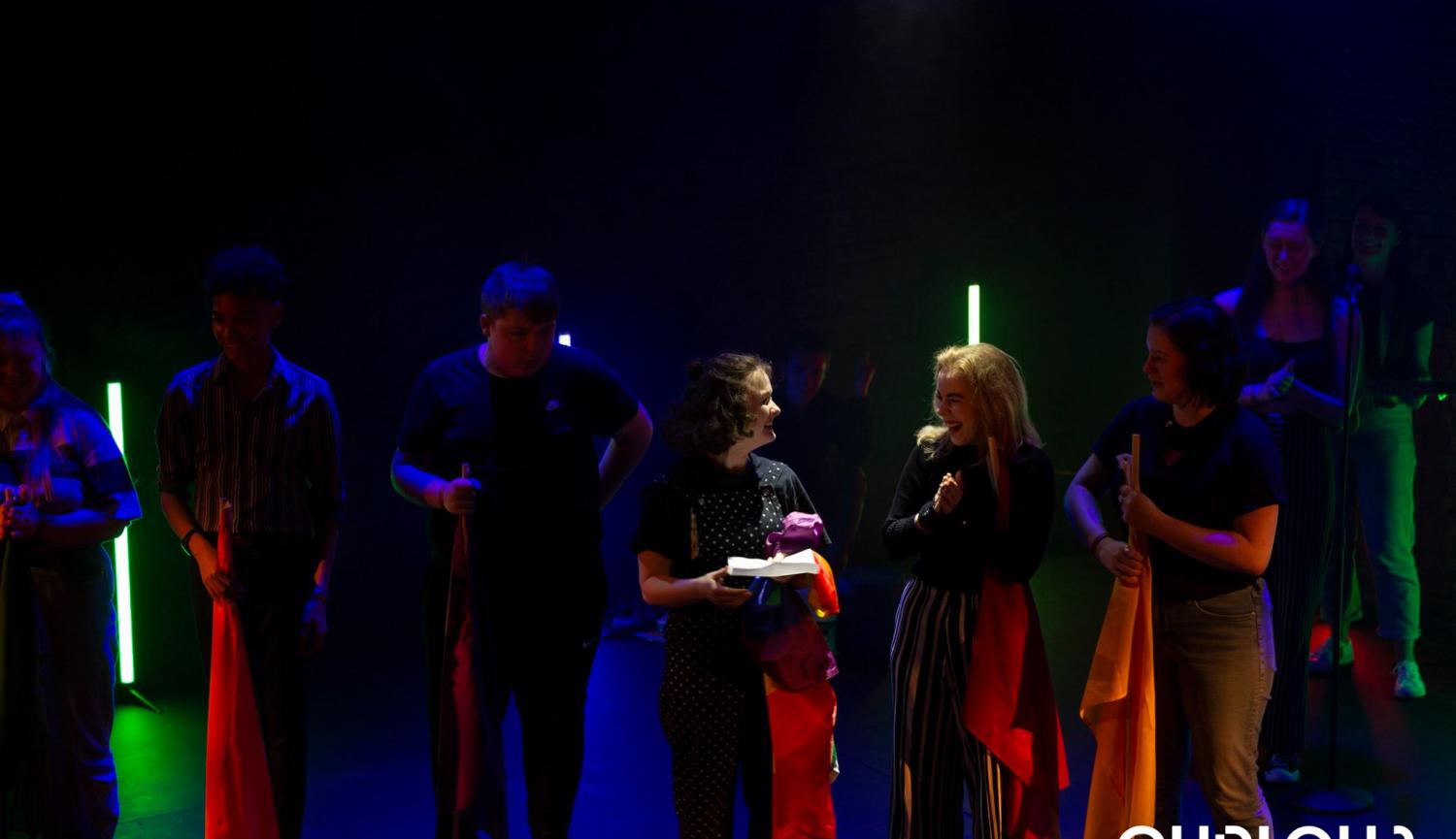 Curious - Young people on a dark stage