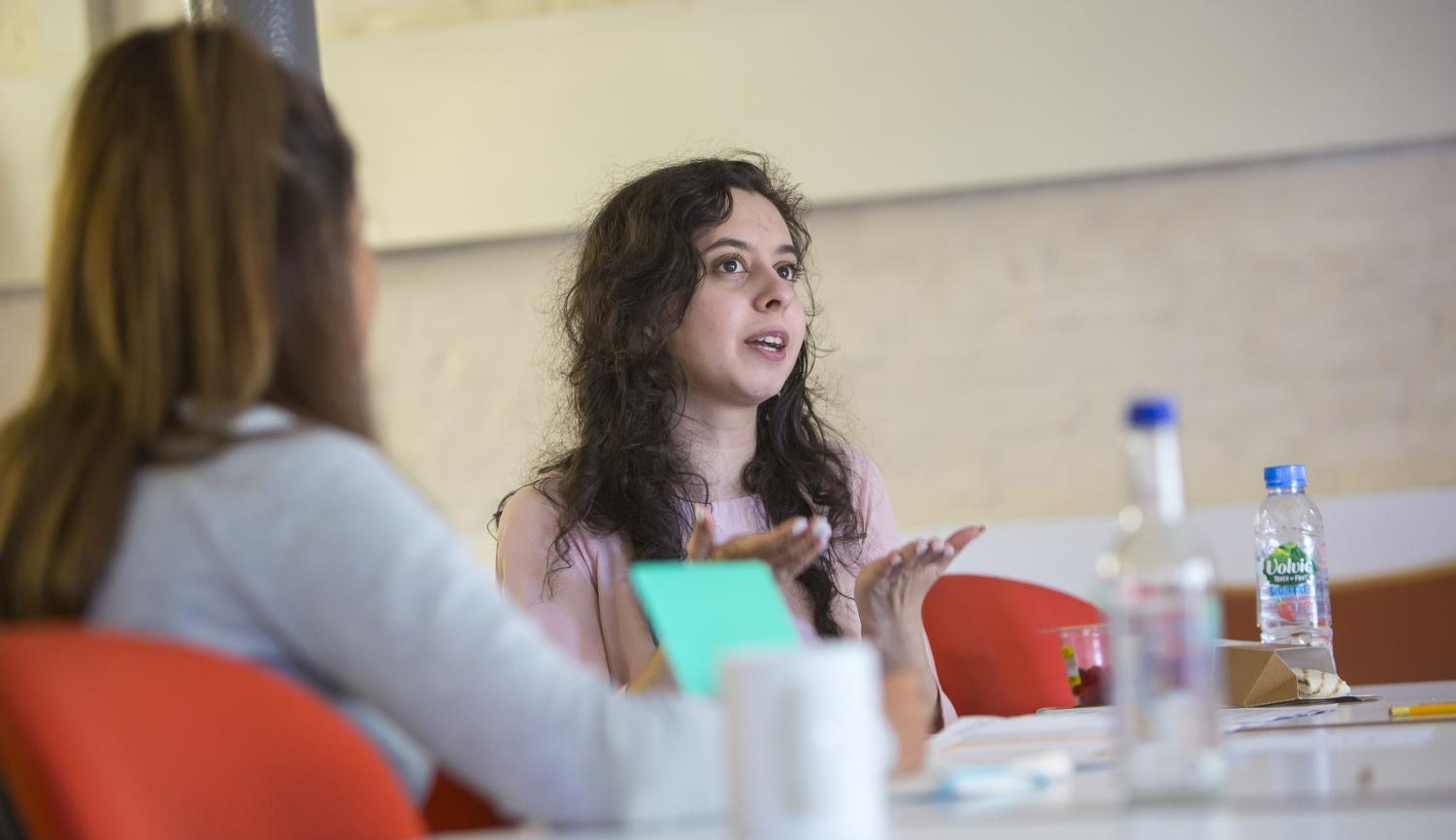 Two women sitting at table talking