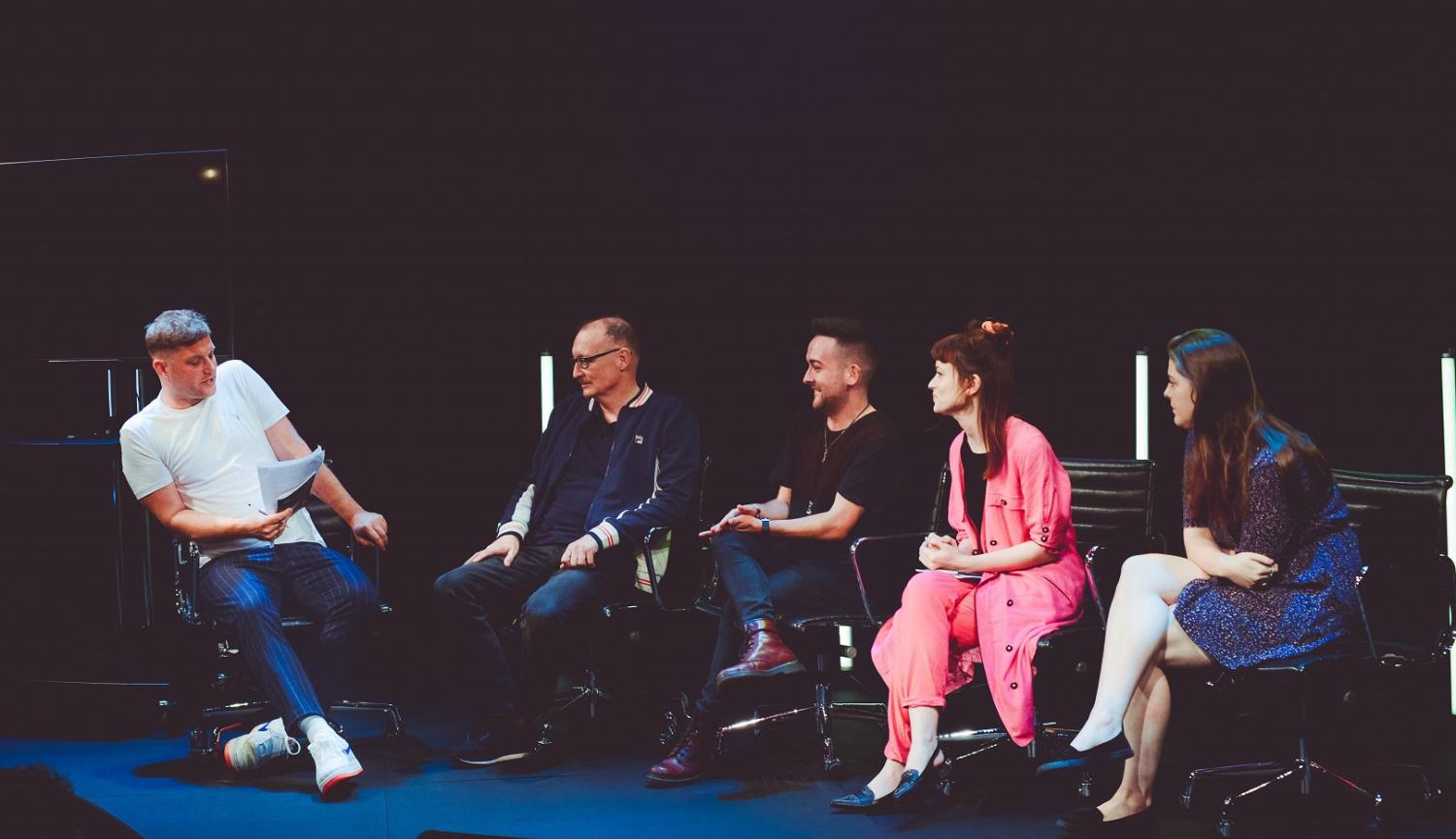 Panel of 5 people on stage