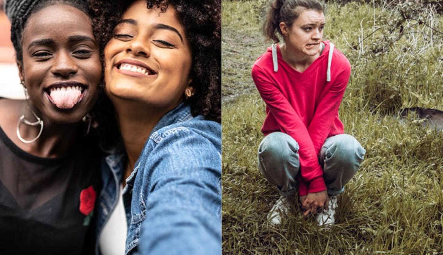 Two girls taking a selfie and another girl crouching down on a grass bank