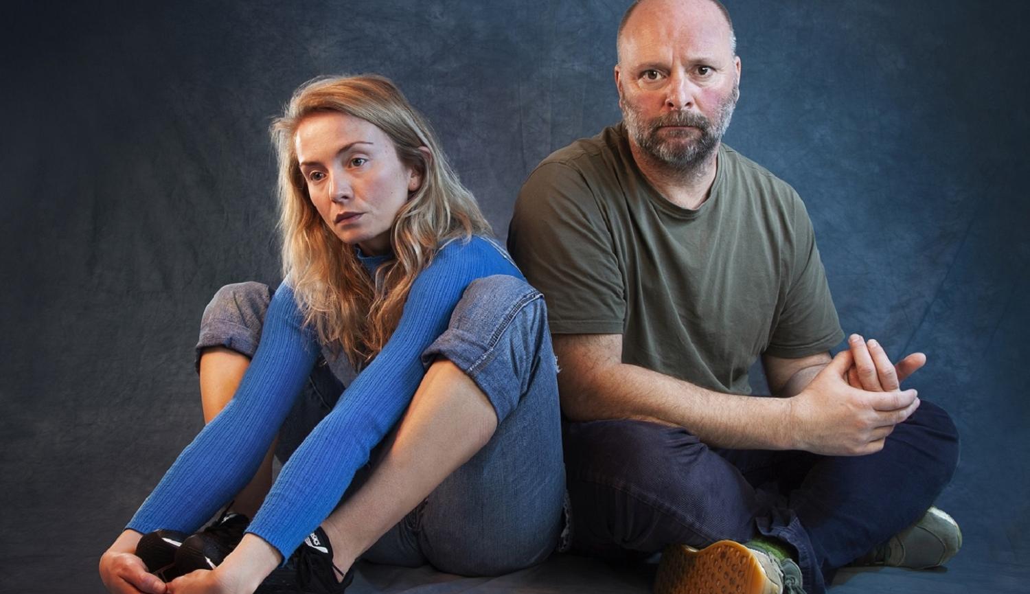 Photo of man and girl sitting on floor