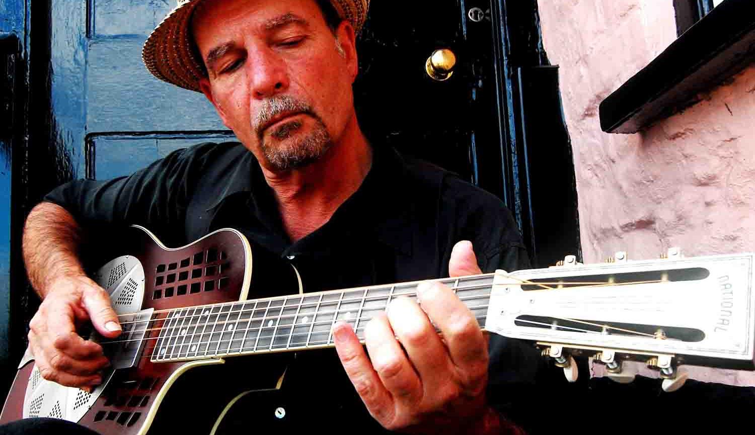 Image of Steve James playing the guitar