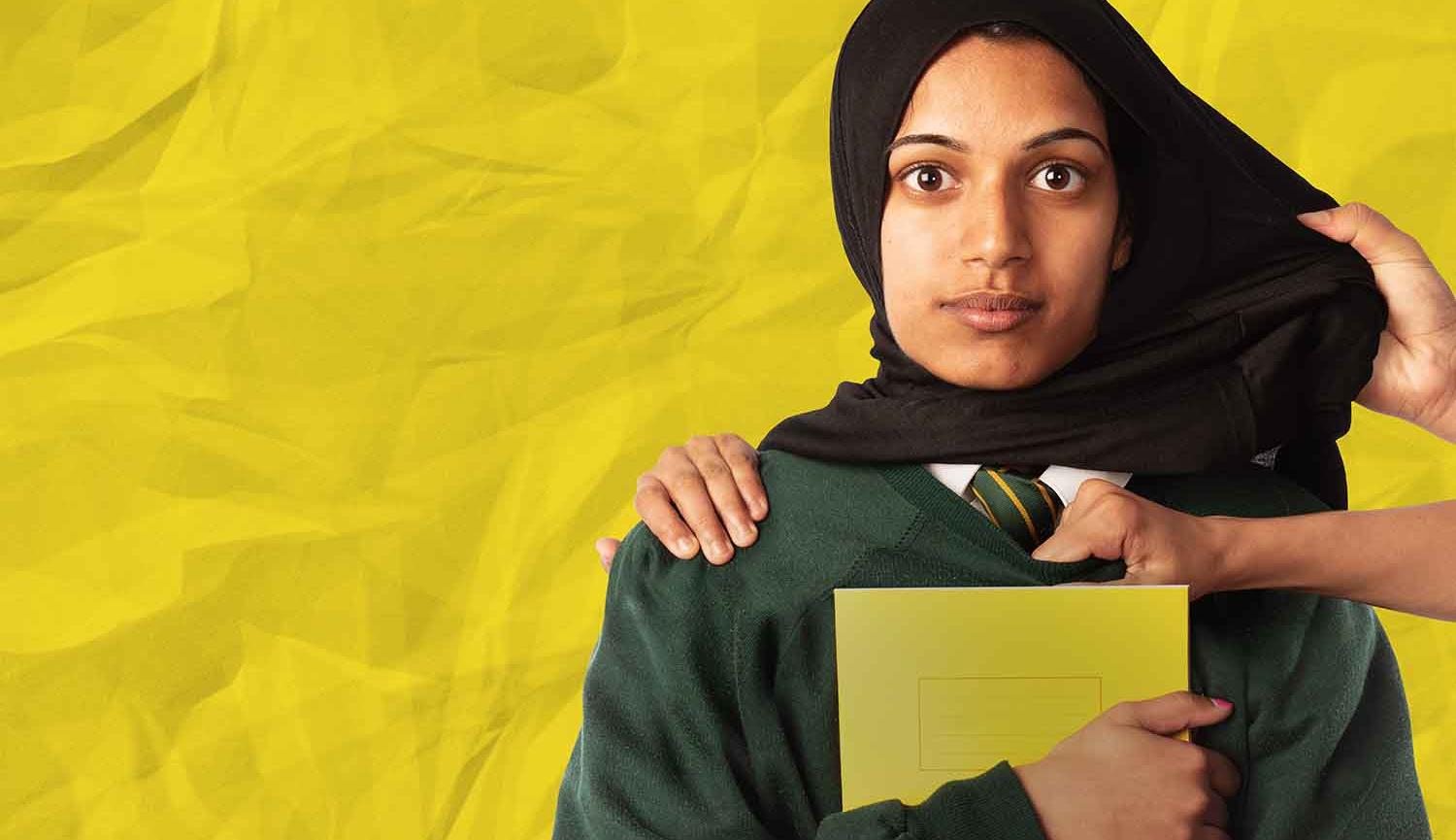 Photo of woman, head and shoulders, standing against yellow wall