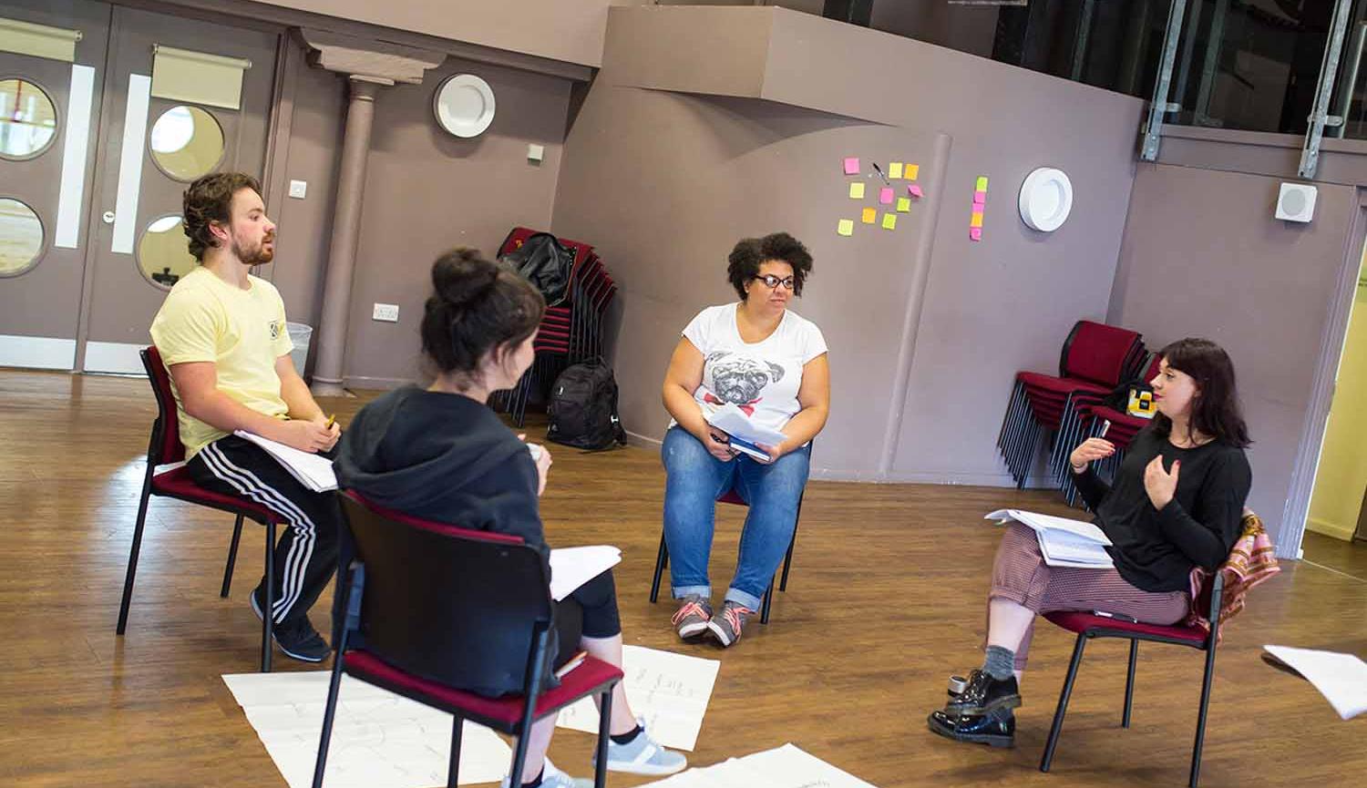 Women and the world image of women siting on chairs in a circle