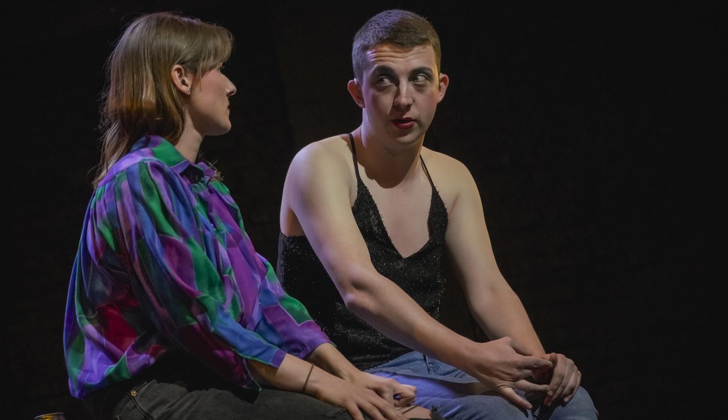 Two people sitting on stage