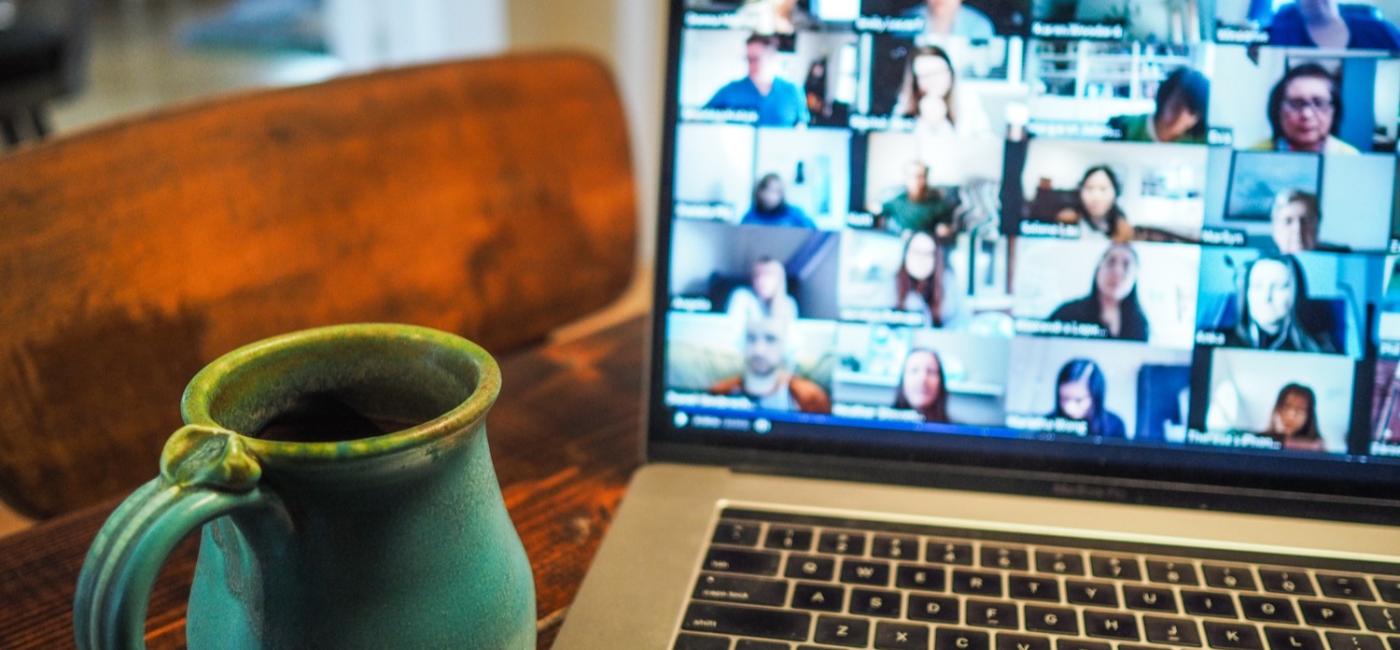 Laptop on desk showing online meeting participants