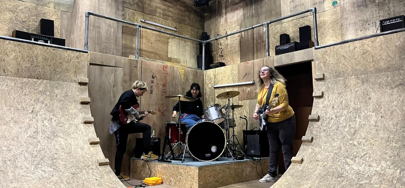 Designer Lily Arnold, Lighting Designer Lucia Sanchez Roldan and Assistant Director Bex Bowsher jamming on the stage of We Are The Best!