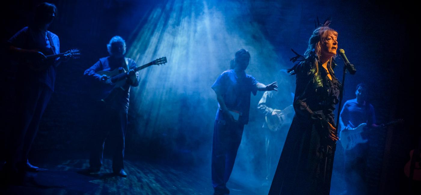 Cast singing on stage