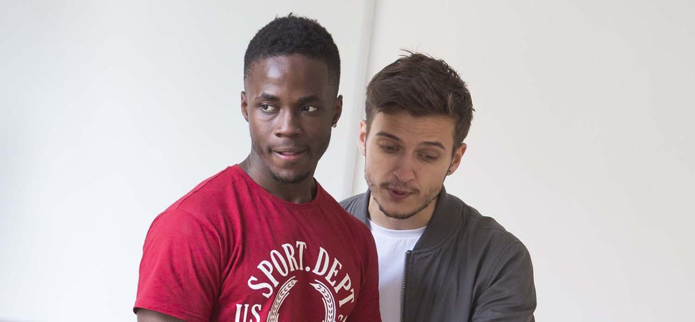 Two men looking at a leaflet 