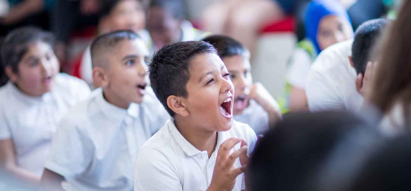 Picture of children siting on floor smiling and laughing