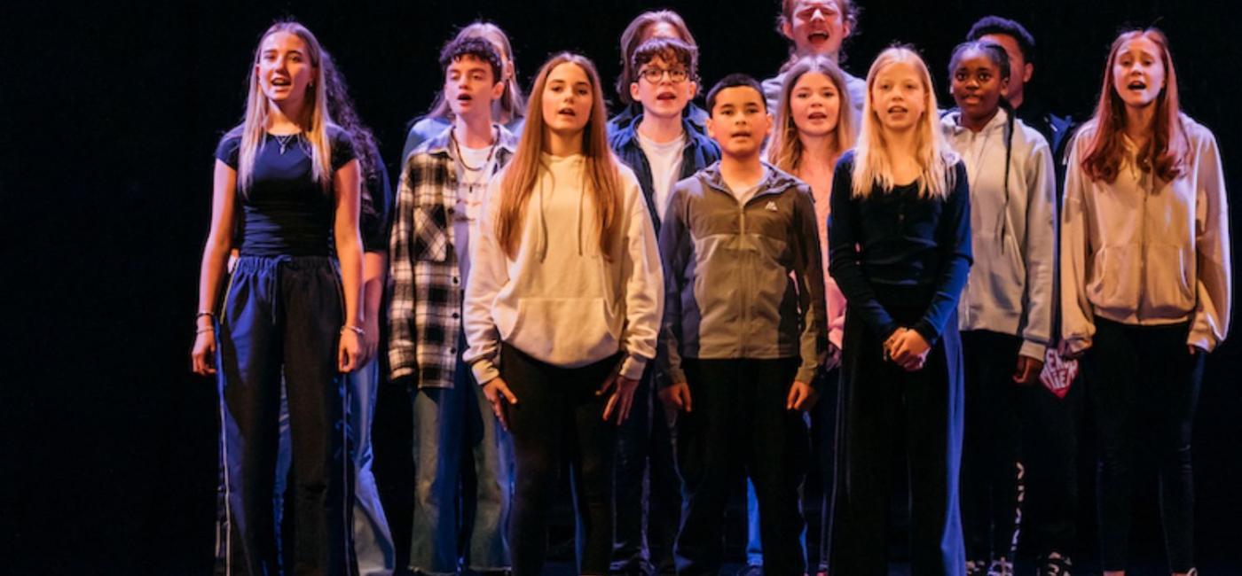 Group of young members of Live Youth Theatre on stage performing Fed Up!