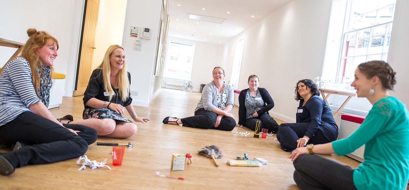 Teachers CPD group sitting on floor