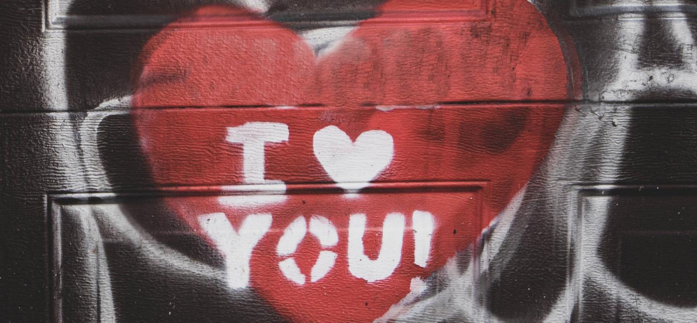 A heart spray painted onto a wall with the words I heart you!