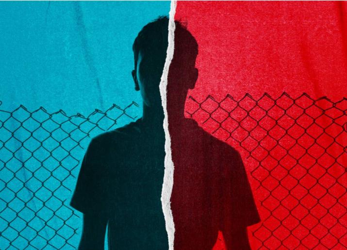 Red and blue image of a young lad behind a chain link fence