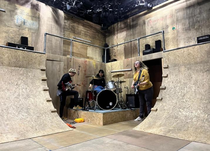 Designer Lily Arnold, Lighting Designer Lucia Sanchez Roldan and Assistant Director Bex Bowsher jamming on the stage of We Are The Best!