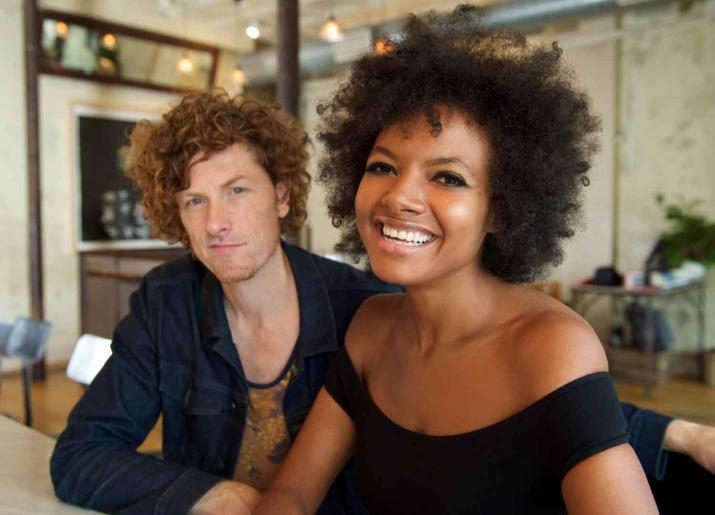 Photo of man and woman sitting at a bar