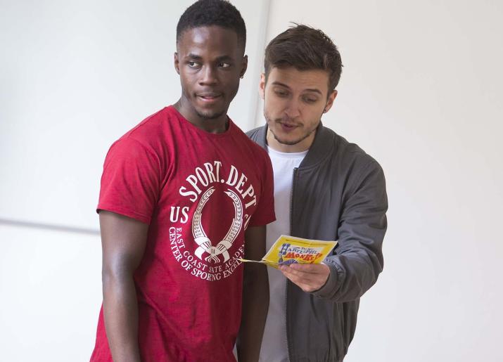 Two men looking at a leaflet 