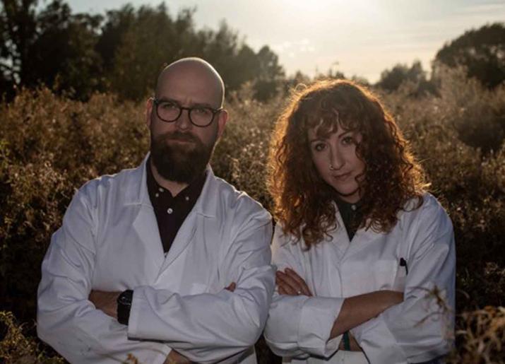 Findlay Napier and Megan Henwood standing side by side wearing white lab coats