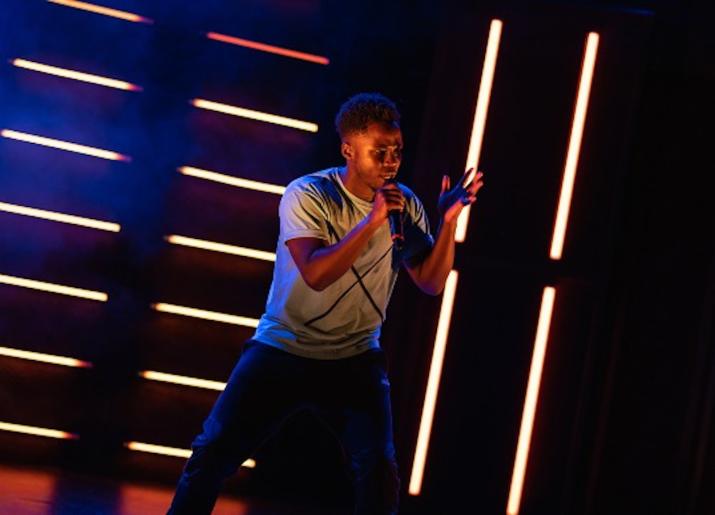 Young man on stage with microphone