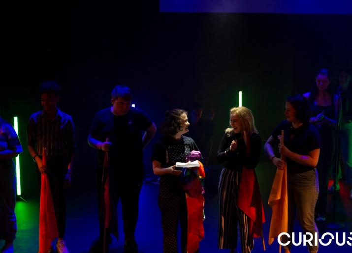 Curious - Young people on a dark stage