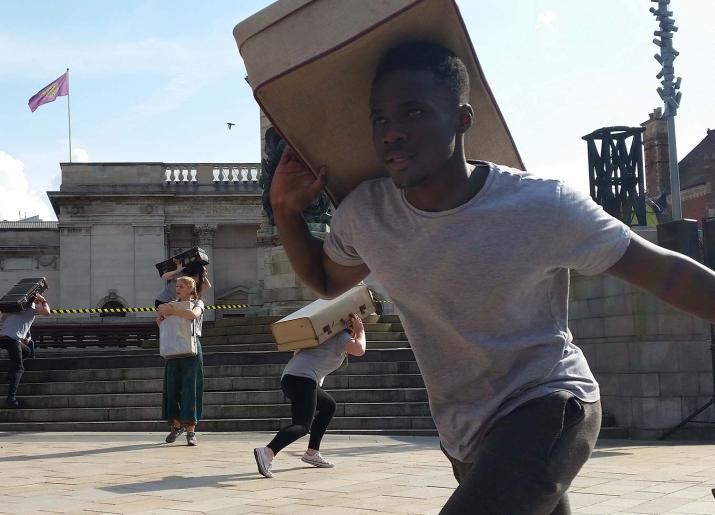 Youth Theatre presentations young man carrying suitcase