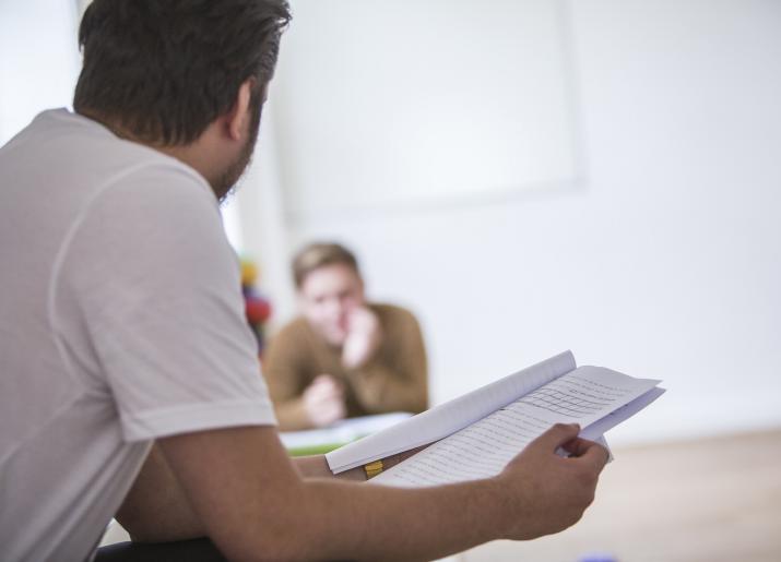 Two people reading scripts