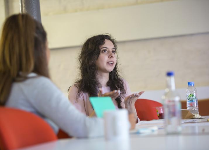 Two women sitting at table talking