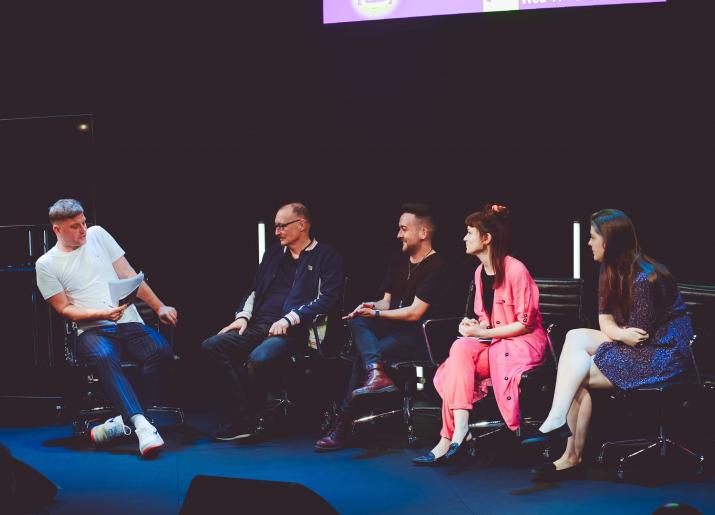 Panel of 5 people on stage