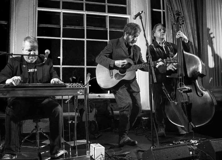 Jumpin Hot Club Peter Bruntnell Trio pic of three men playing drums guitar and double bass