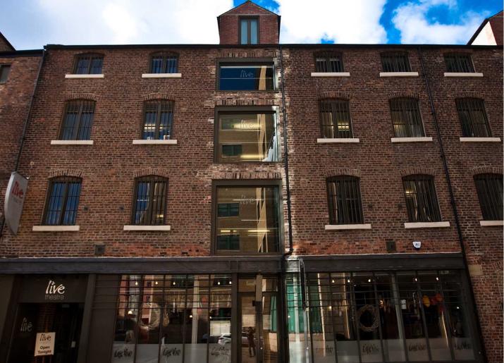 Photo of front of old three storey brick building