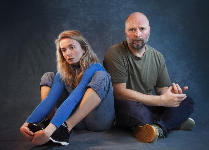 Photo of man and girl sitting on floor