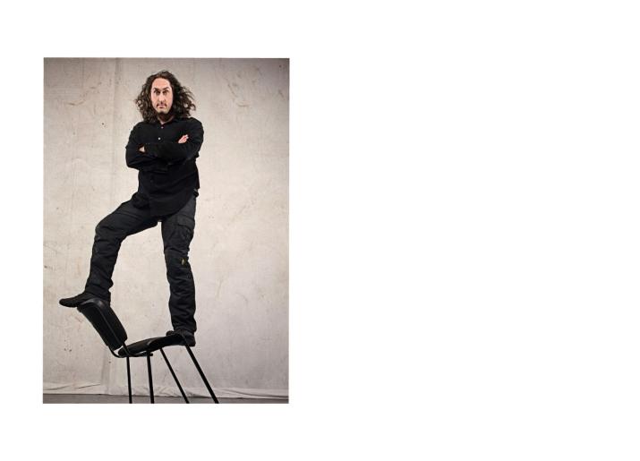 Ross Noble standing on a chair