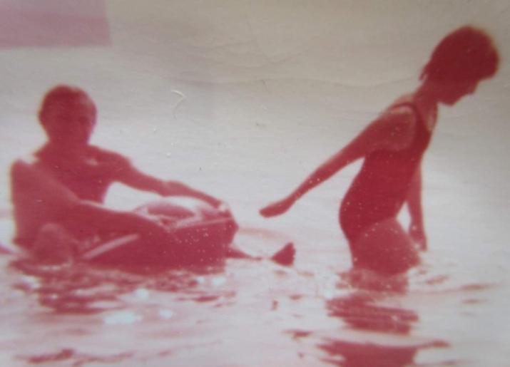 Sepia photograph of two people in the sea