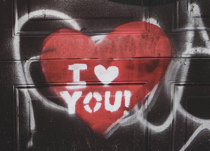A heart spray painted onto a wall with the words I heart you!
