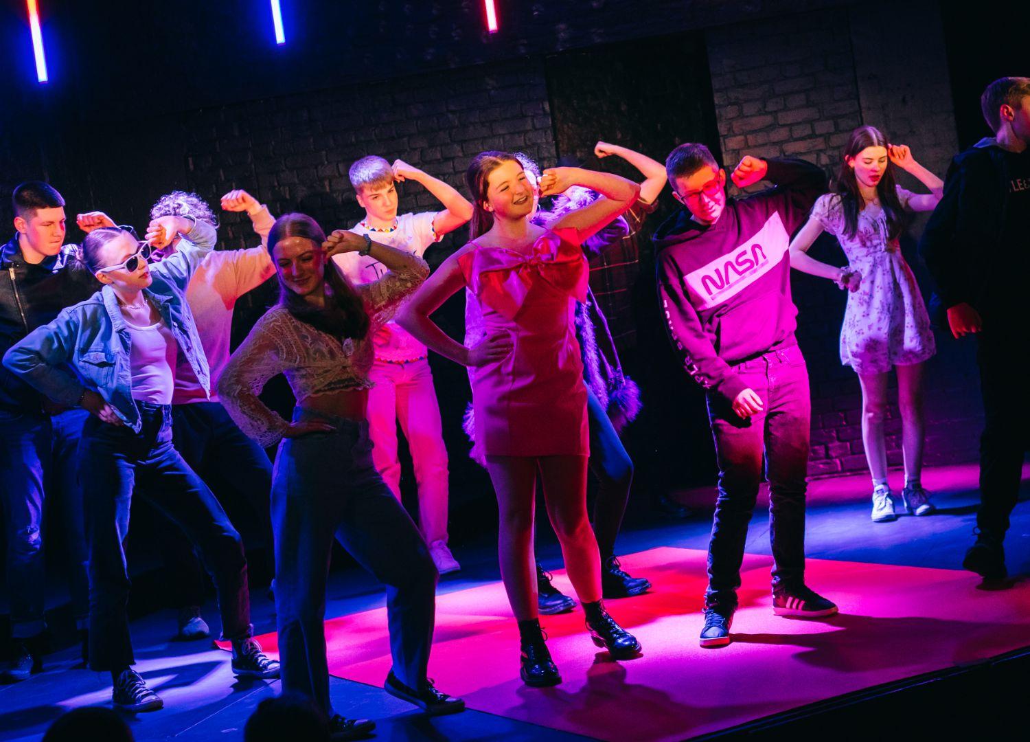 Ten Youth Theatre members on stage dancing