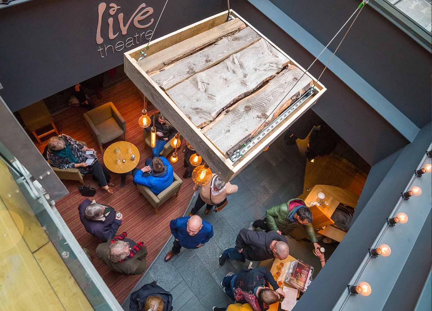 Atrium bar from above with people sitting at tables